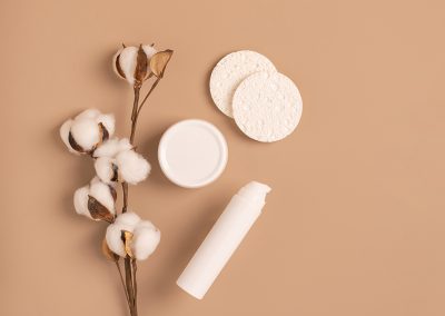 Brown background with white cosmetics bottle